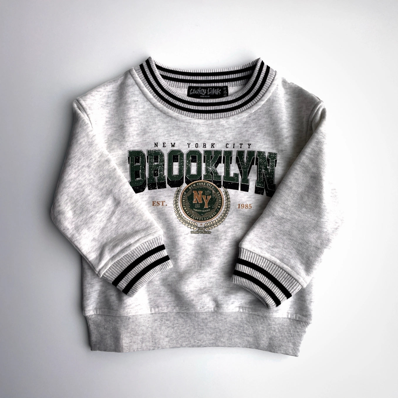Toddler vintage inspired Brooklyn crew sweatshirt with retro graphic and striped cuffs, perfect for stylish comfort.