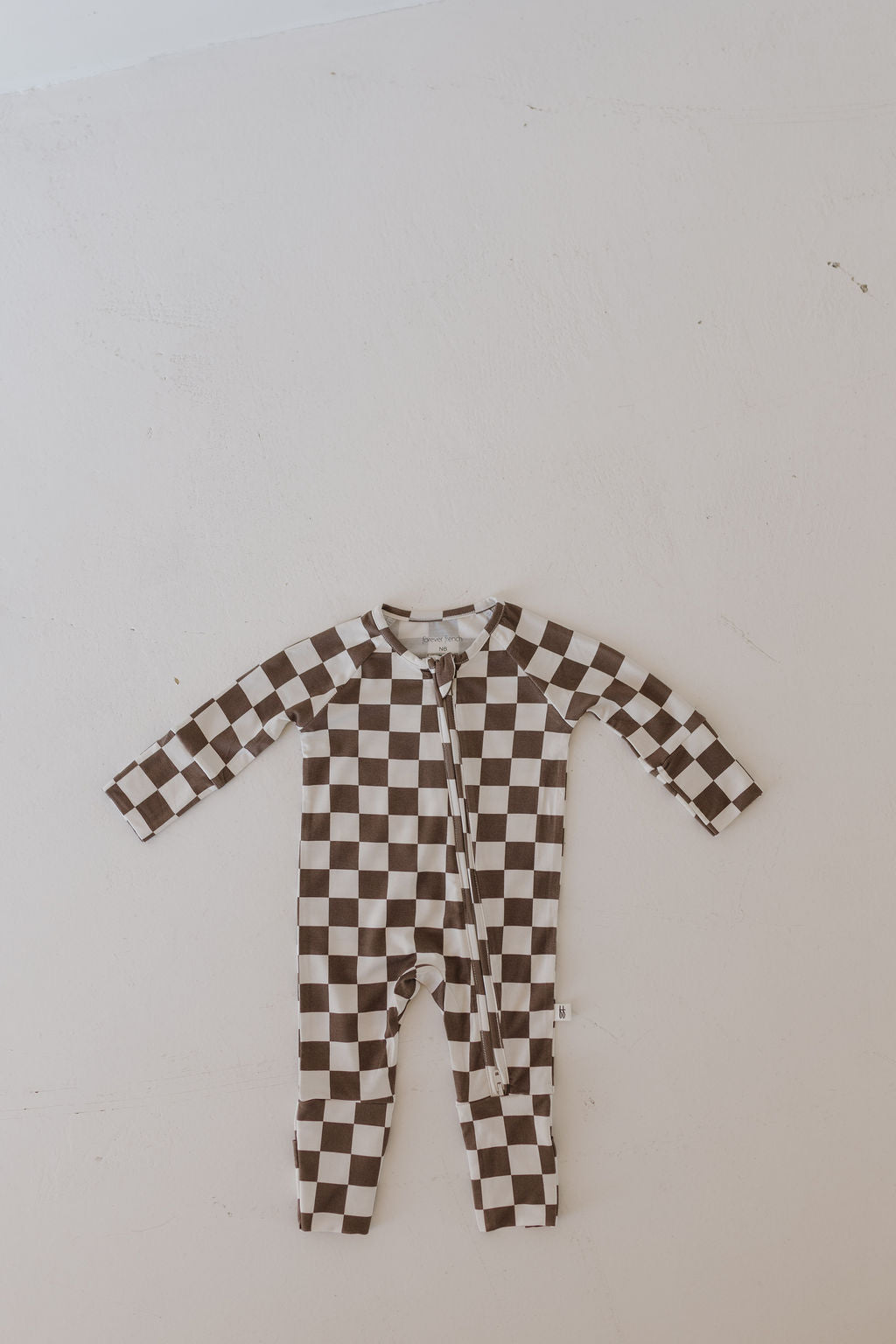 Bamboo zip pajamas by Dutton in brown and white checkerboard pattern for infants, perfect for sleep and play.