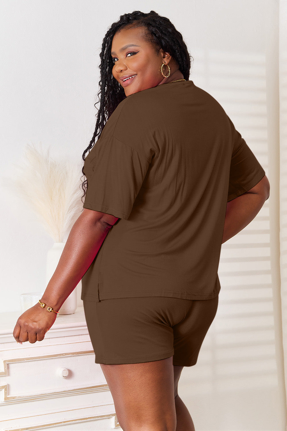 Model wearing a brown Basic Bae soft rayon half sleeve top and shorts set from behind, showcasing a relaxed, comfy style.