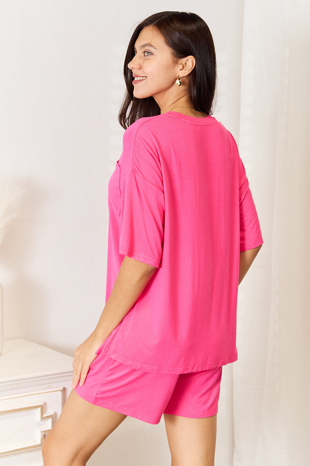 Model wearing a pink Basic Bae soft rayon half-sleeve top and shorts set, showcasing a relaxed and stylish everyday outfit.
