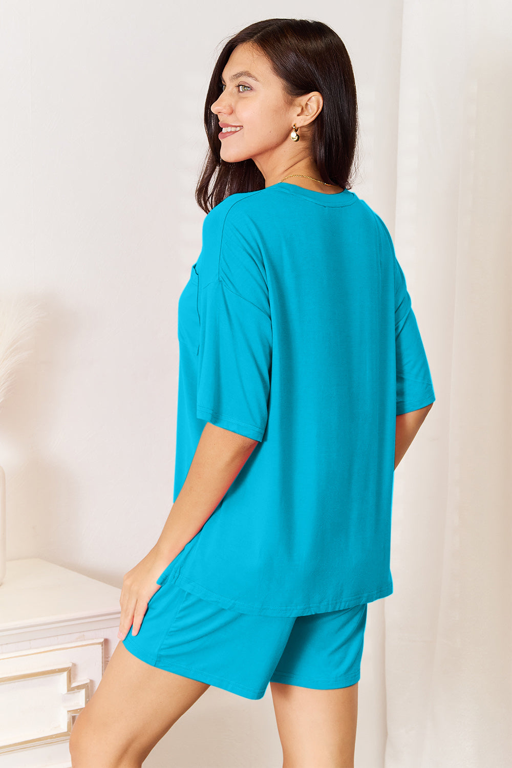 Model wearing a turquoise Basic Bae soft rayon half-sleeve top and shorts set, showcasing relaxed style and comfort.