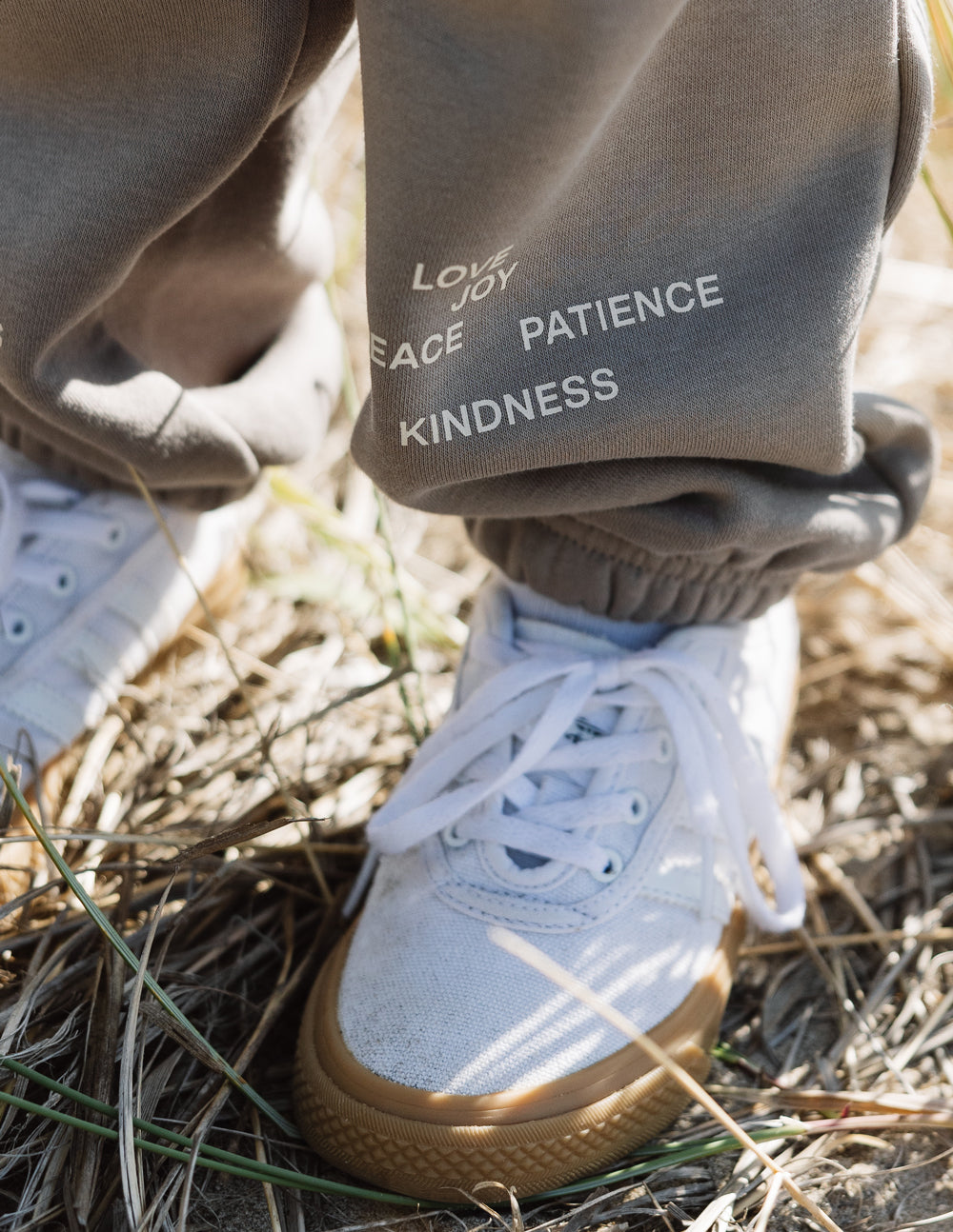 Close-up of Fruit of the Spirit kids sweatpant, showcasing inspirational words: love, joy, peace, patience, kindness.