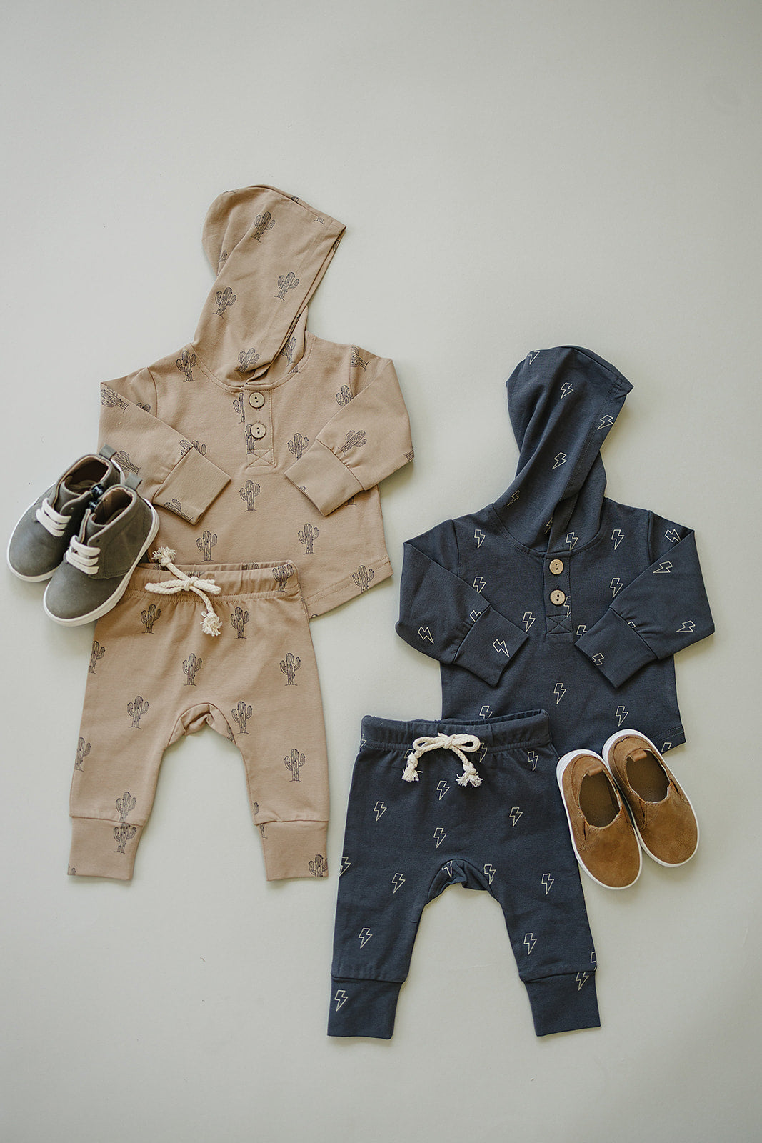 Boys lightning bolt school outfit featuring hooded sets in beige and navy with jogger bottoms and stylish shoes.