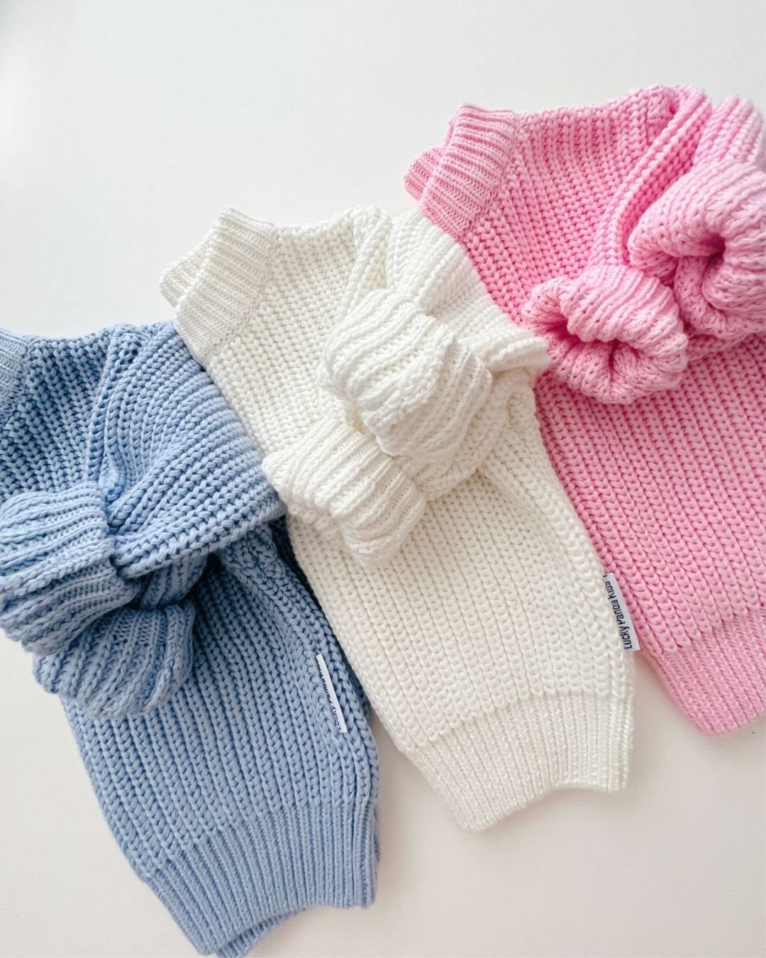 Chunky Knit Sweater in blue, white, and pink, showcasing soft ribbed texture and cozy oversized fit.