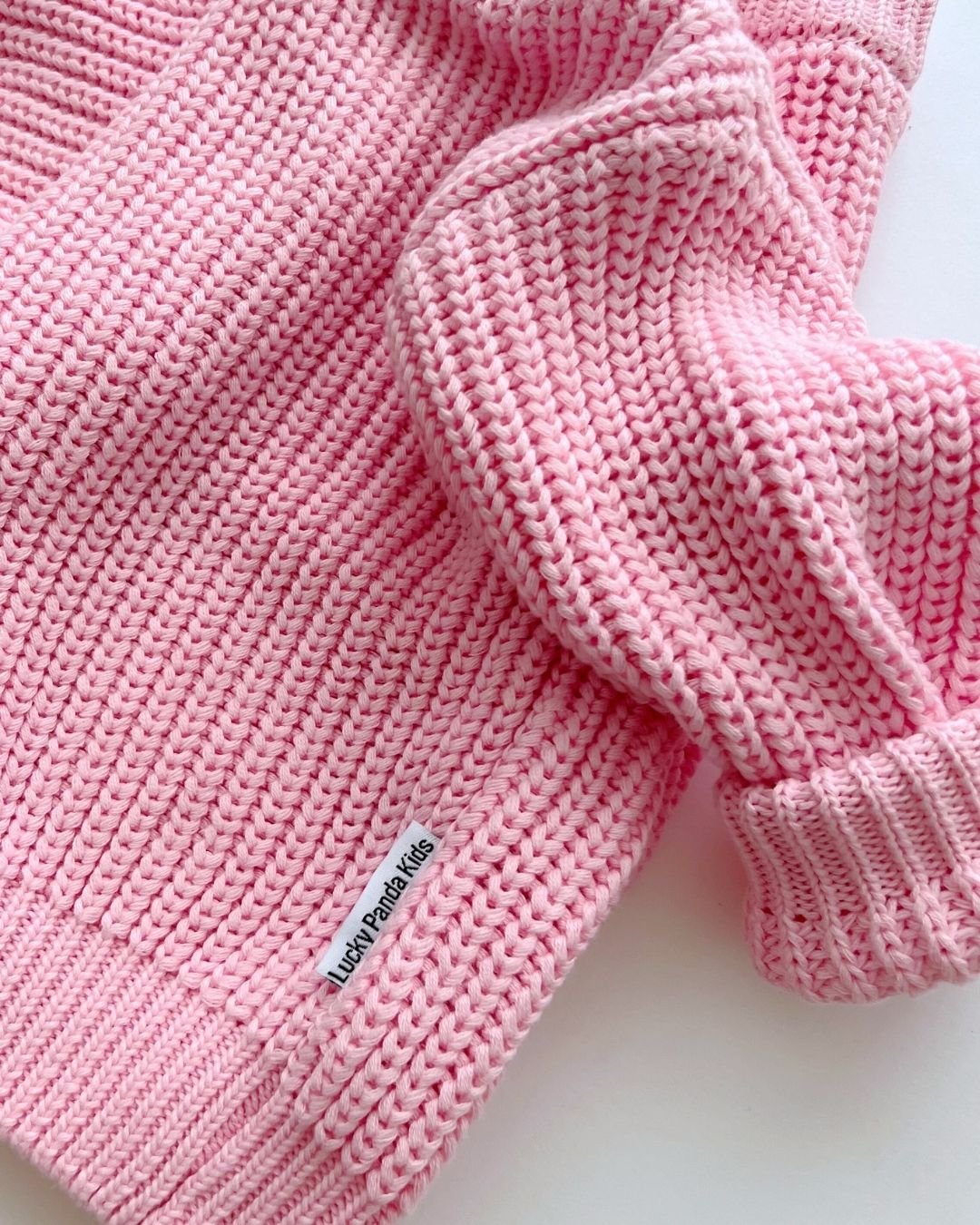 Chunky Knit Sweater in pink showcasing soft cotton texture and relaxed fit, ideal for cozy layering.