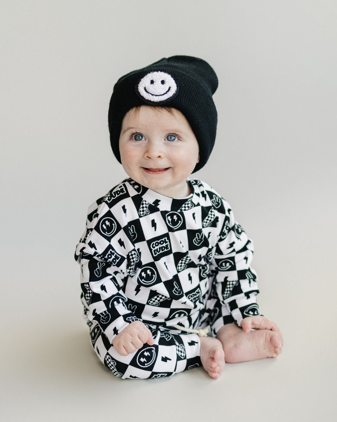 Baby wearing Cool Dude Jogger Set with smiley beanie, showcasing playful style and comfort for kids.