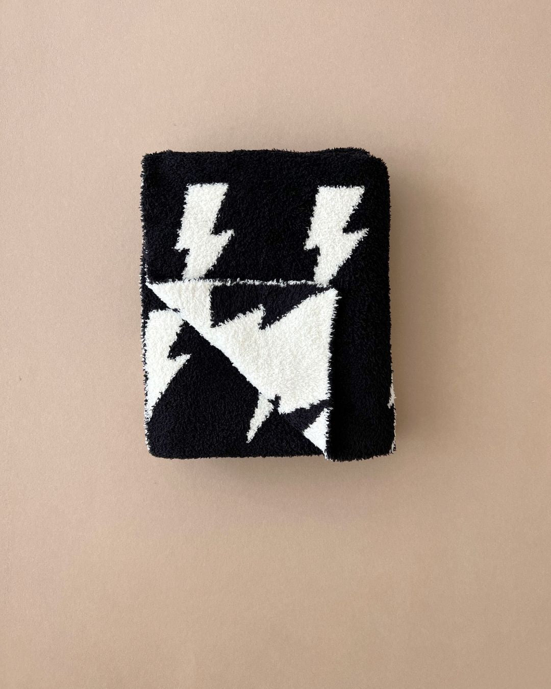 Lightning Bolt Fuzzy Blanket folded in black and white, featuring a fun lightning bolt design, perfect for baby comfort.