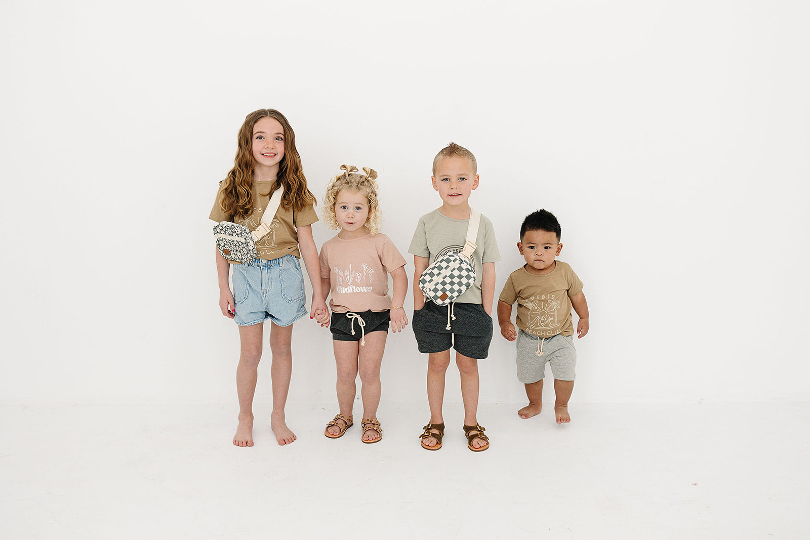 Kids wearing trendy outfits, featuring a green checkered mini fanny pack, perfect for stylish day trips.