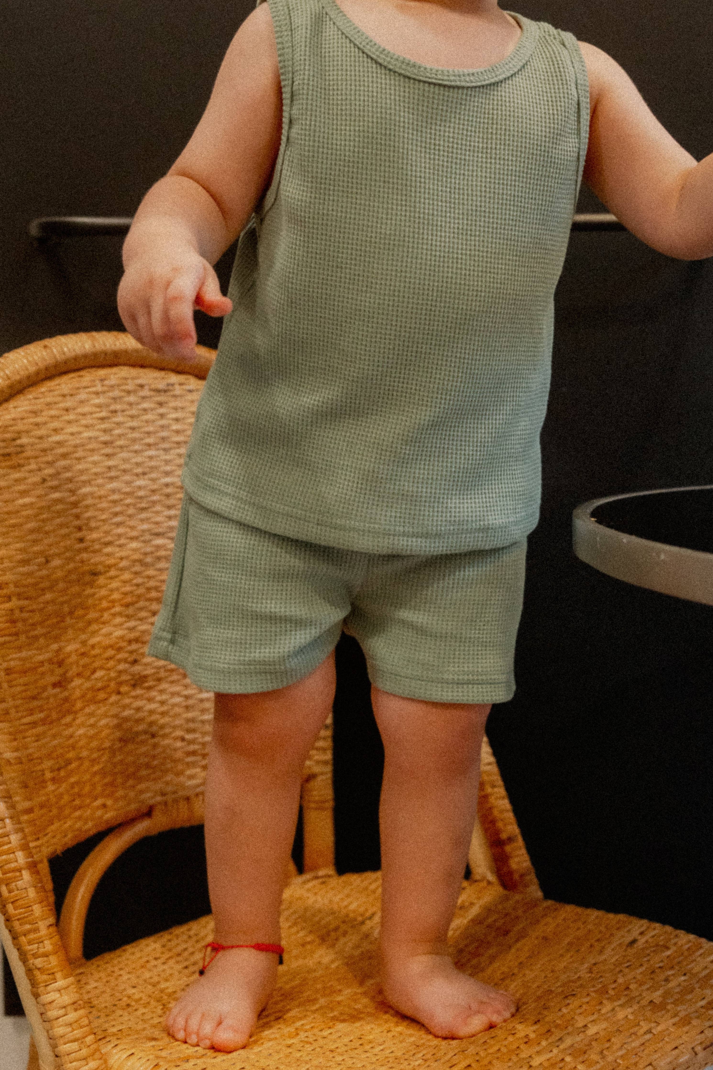 Toddler in a teal lightweight tank and shorts set, perfect for summer days and relaxed play.