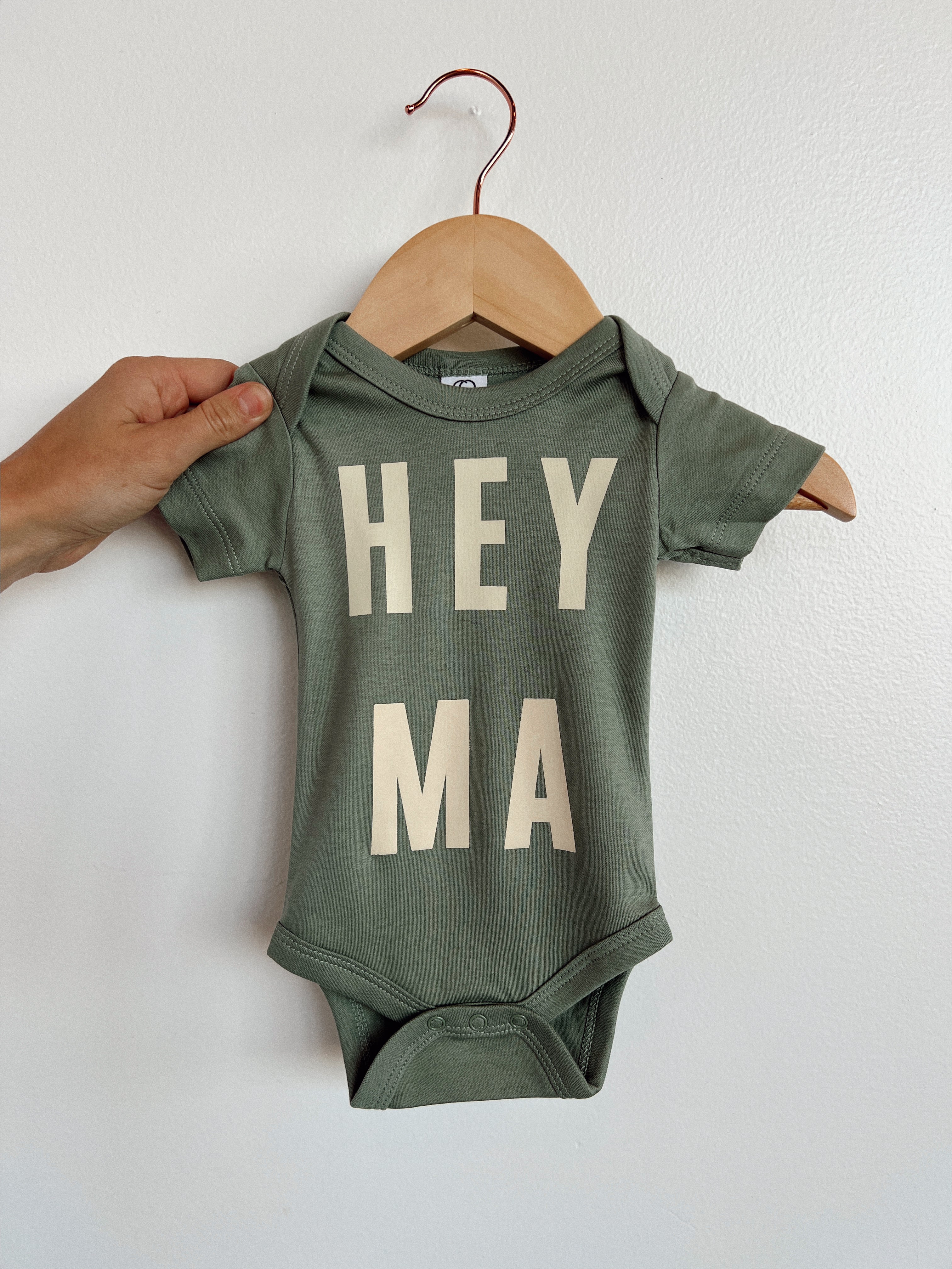 Hey Ma organic baby onesie in soft green cotton, perfect gift for trendy, gender-neutral baby fashion.