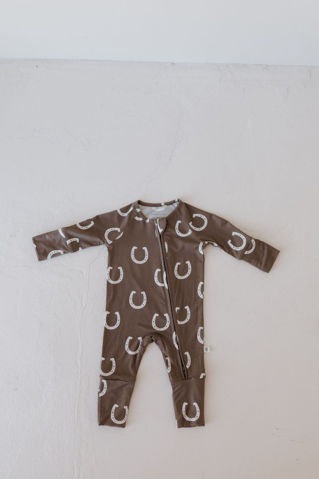 Bamboo zip pajamas giddy up for babies, featuring a brown horseshoe print and easy double zipper for quick changes.