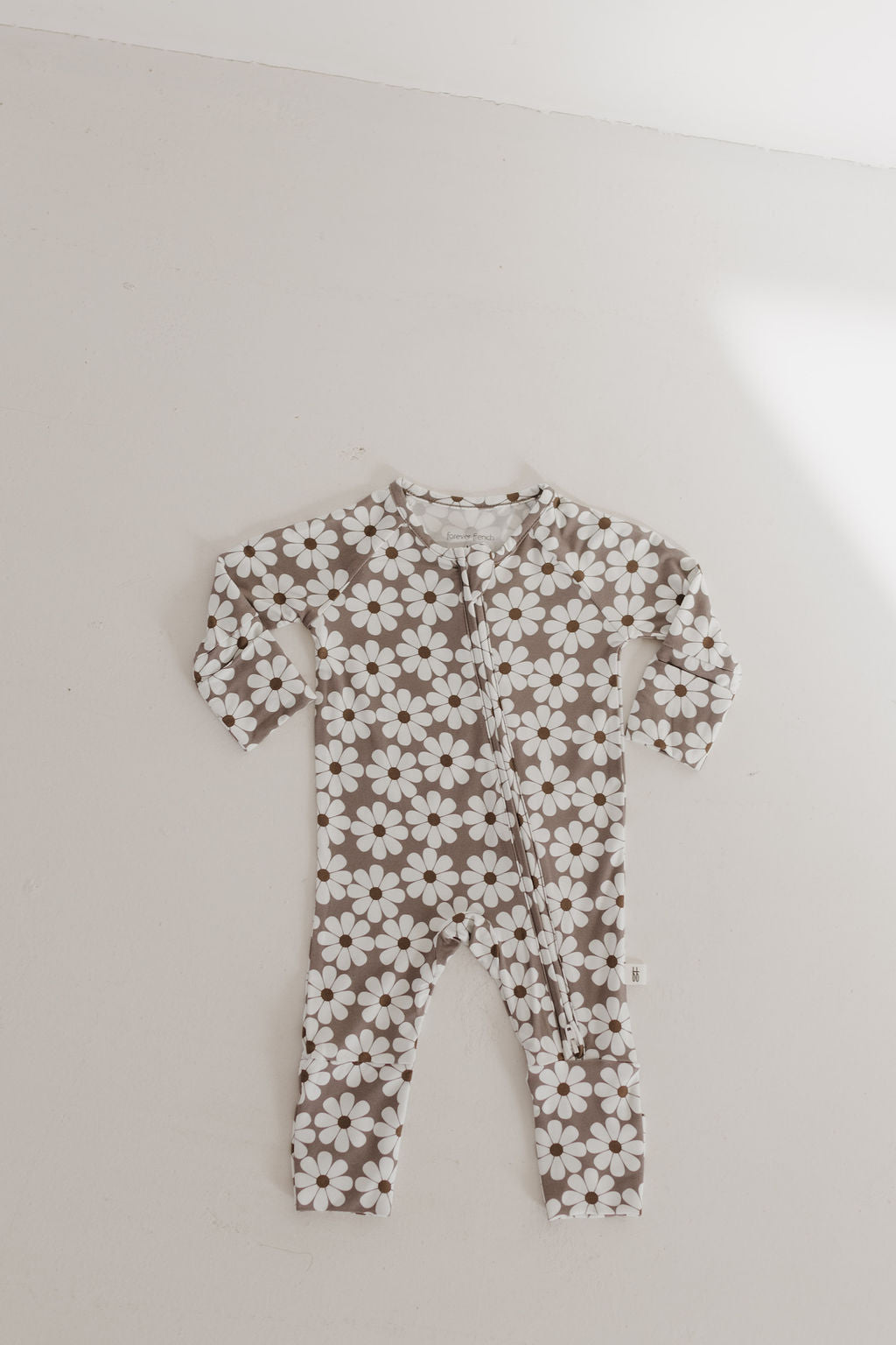 Bamboo zip pajamas darlin' for babies, featuring a brown and white floral print, perfect for cozy sleep.
