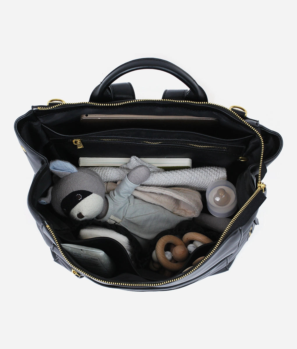 Interior view of a Square Diaper Bag Backpack showing organized baby essentials and toys.