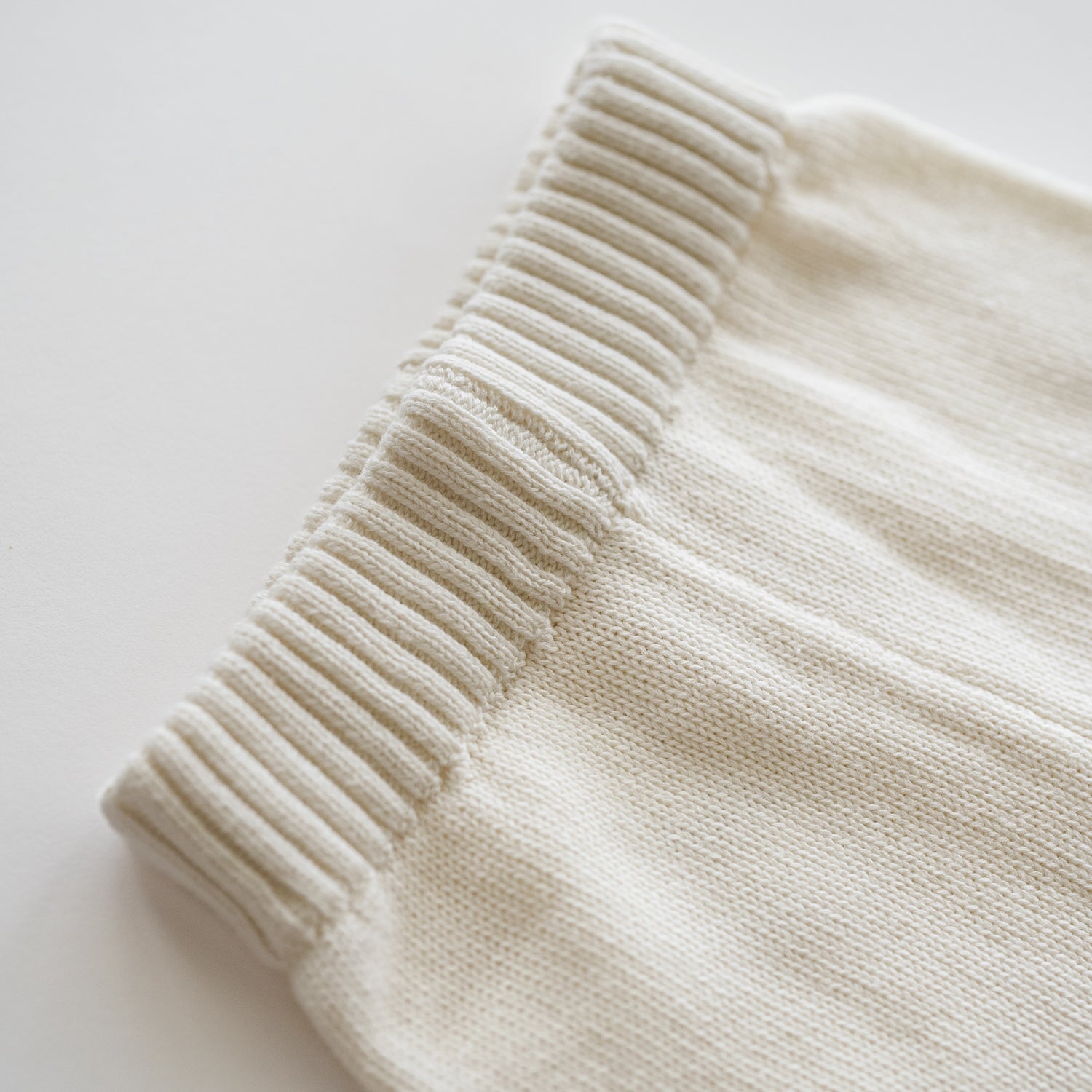 Close-up of the waistline of the Organic Knit Oversized Pant in Ecru, showcasing its soft texture and comfy design.