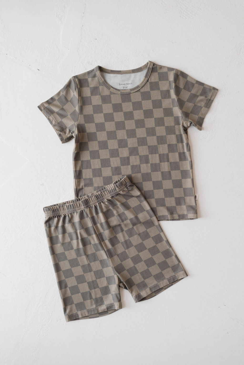 Bamboo baby short set in faded brown checkerboard design, featuring a relaxed tee and shorts for toddlers.