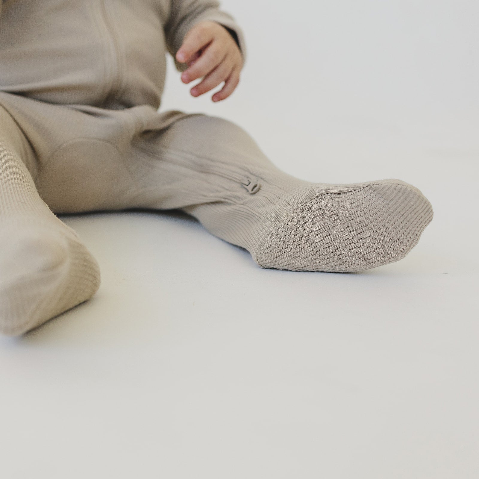 Cozy oatmeal organic baby zipper pajamas with ribbed fabric, perfect for comfy everyday wear.