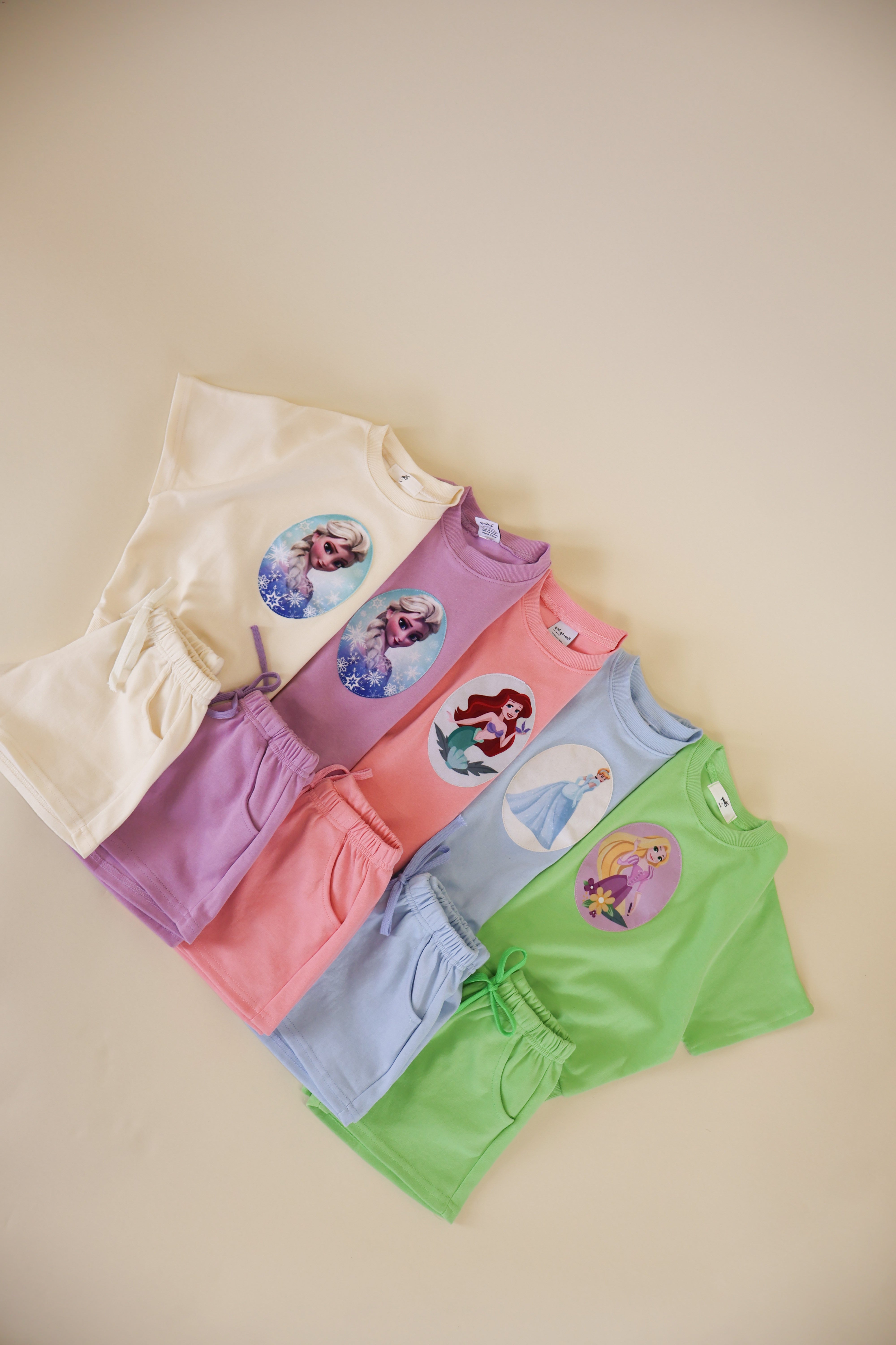 Toddler girl princess short set with colorful tops featuring princess prints and matching shorts.