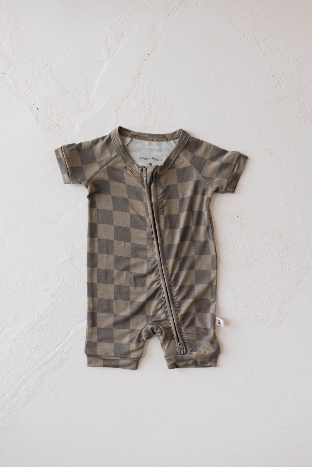 Faded brown checkerboard baby romper with short sleeves and double zipper for easy changes.