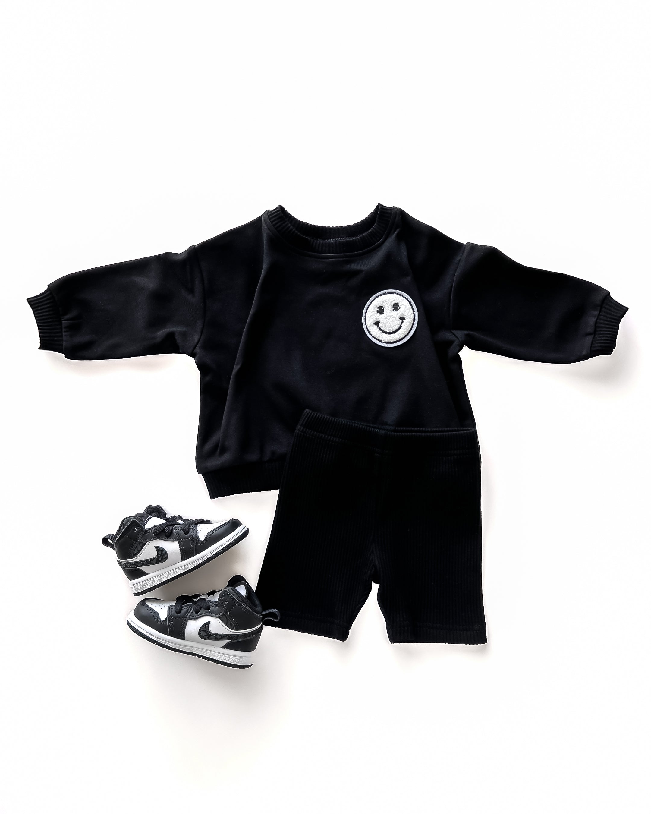 Biker Shorts Set in black, featuring oversized sweatshirt and matching shorts with sneakers, perfect for lounging.