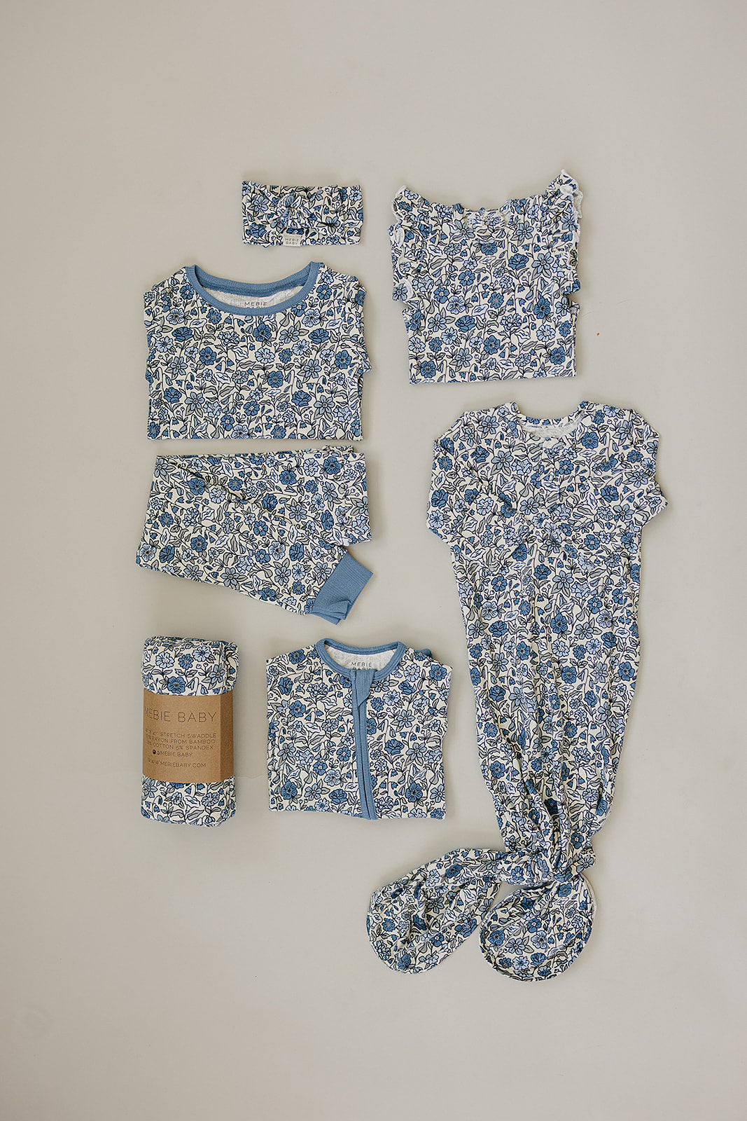 Bamboo Stretch Swaddle Bluebell Pointelle baby wrap in floral design, including swaddle, top, pants, and headband.