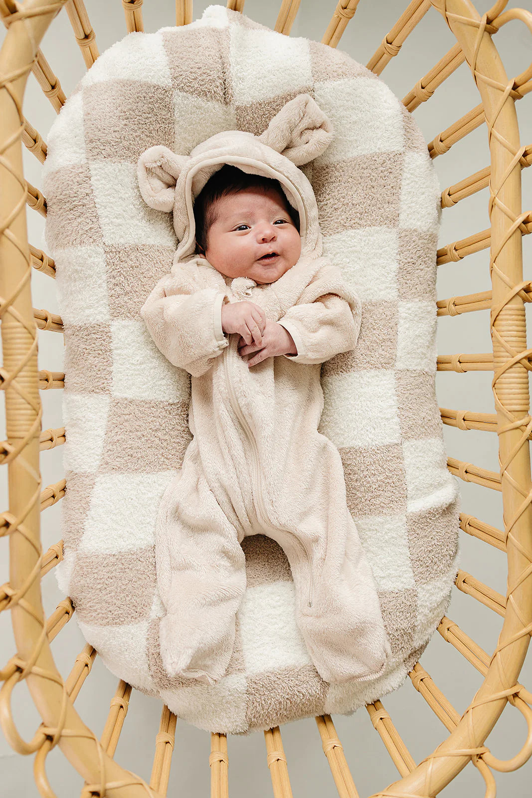 Baby Fleece Bear Hooded Romper with Ears on a cozy blanket, showcasing adorable design and warmth for infants.