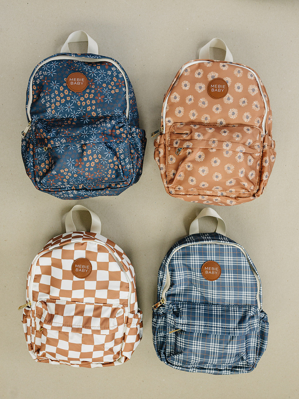 Four kids mini backpacks in various patterns: floral, plaid, checkered, and solid. Perfect for toddlers and preschoolers.