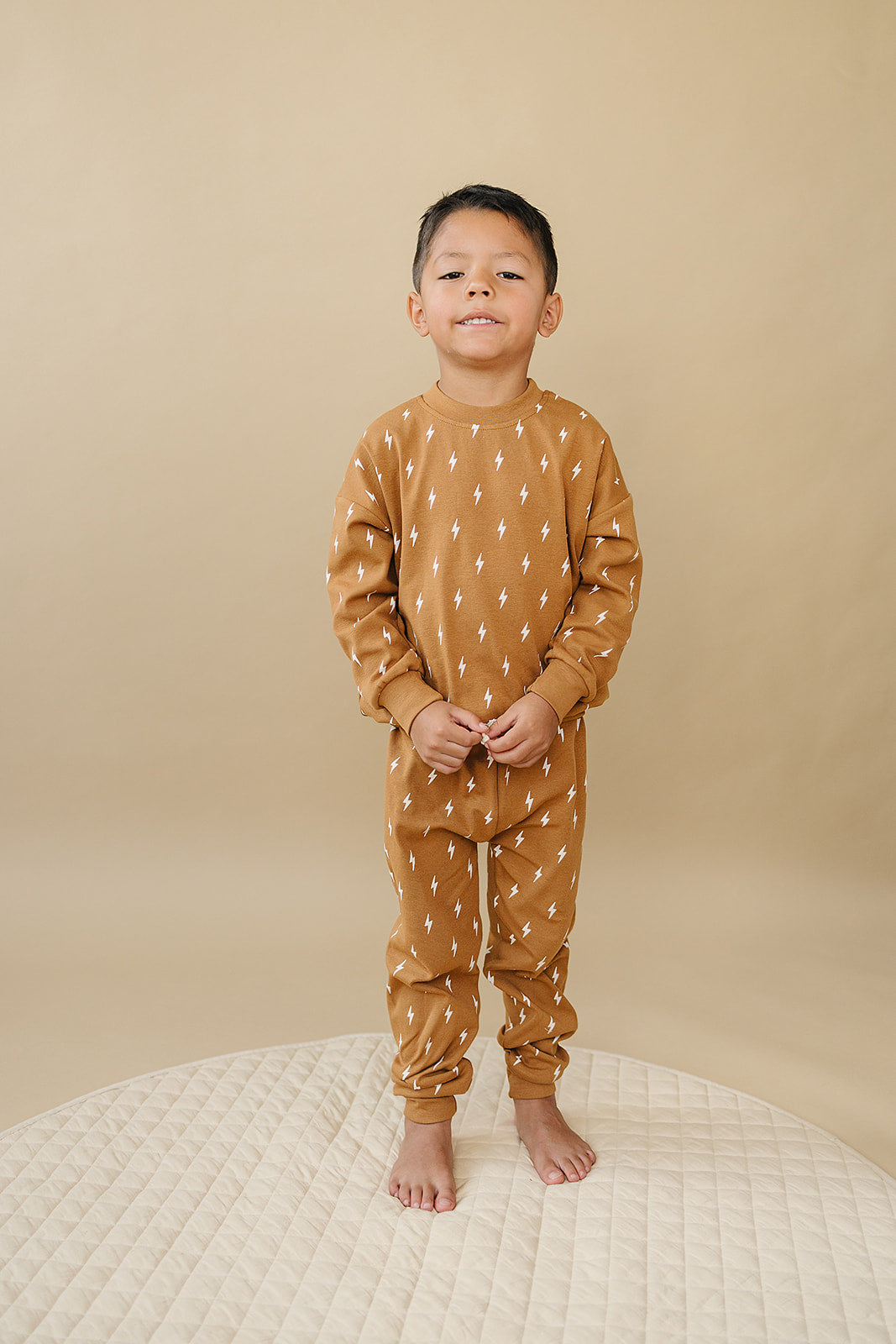 Fall Bolts Kids Lounge Set - Baby & Toddler Outfit featuring a child in cozy lightning bolt print loungewear.
