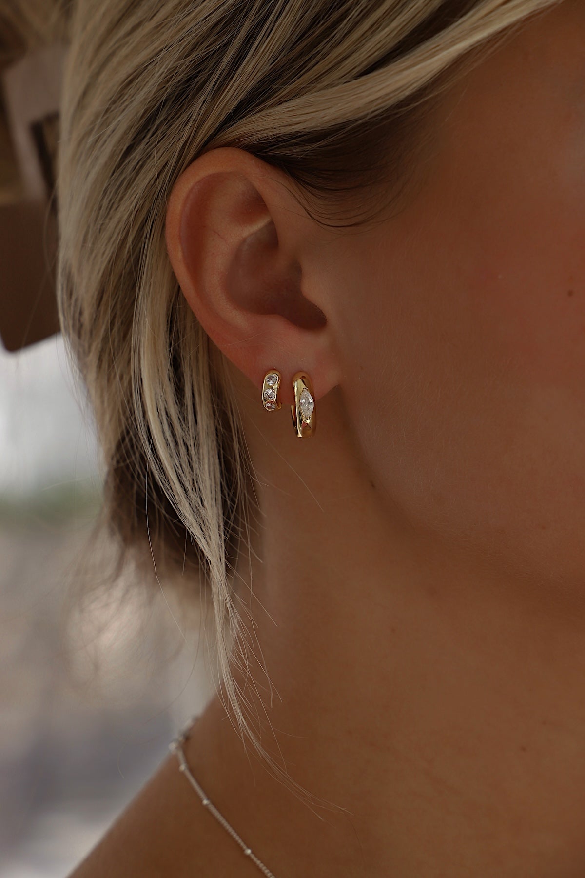Model wearing Aurum Hoops, lightweight gold-toned earrings, perfect for everyday wear and elegant outfits.