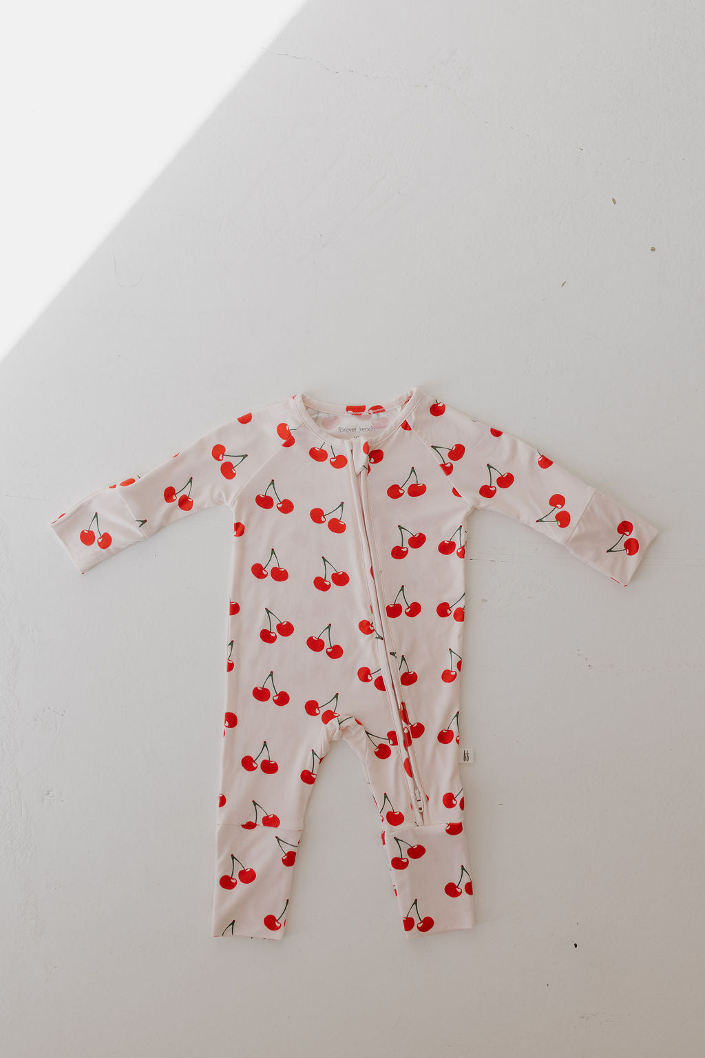 Bamboo zip pajamas in cherry print, perfect for cozy sleep, featuring a double zipper and fold-over cuffs.