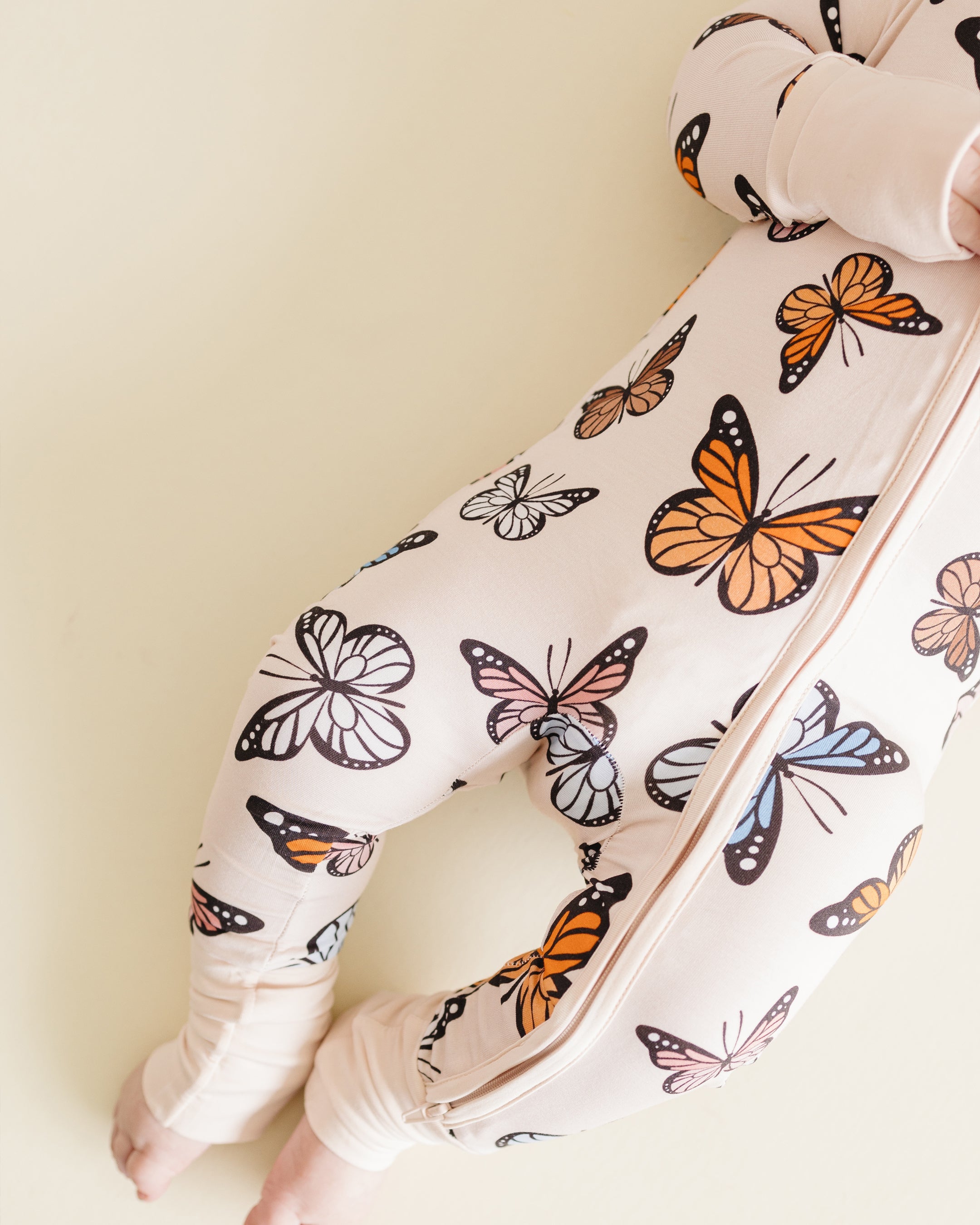 Bamboo zip romper featuring colorful butterfly print for babies, designed for comfort and easy diaper changes.