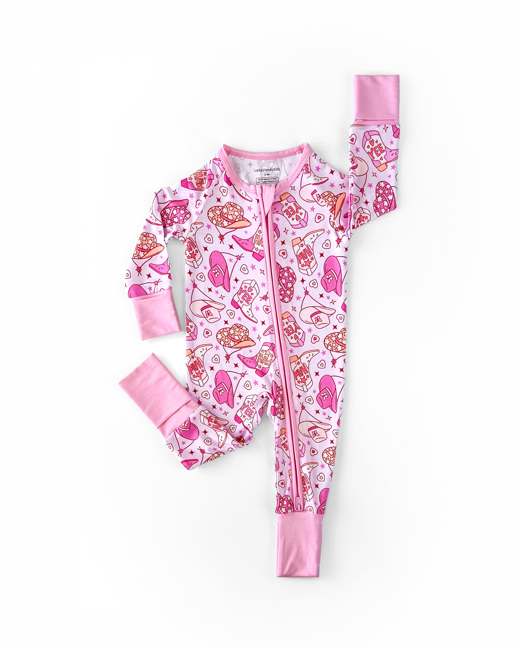 Bamboo zip romper for baby in pink with playful cowgirl print featuring boots and hats.