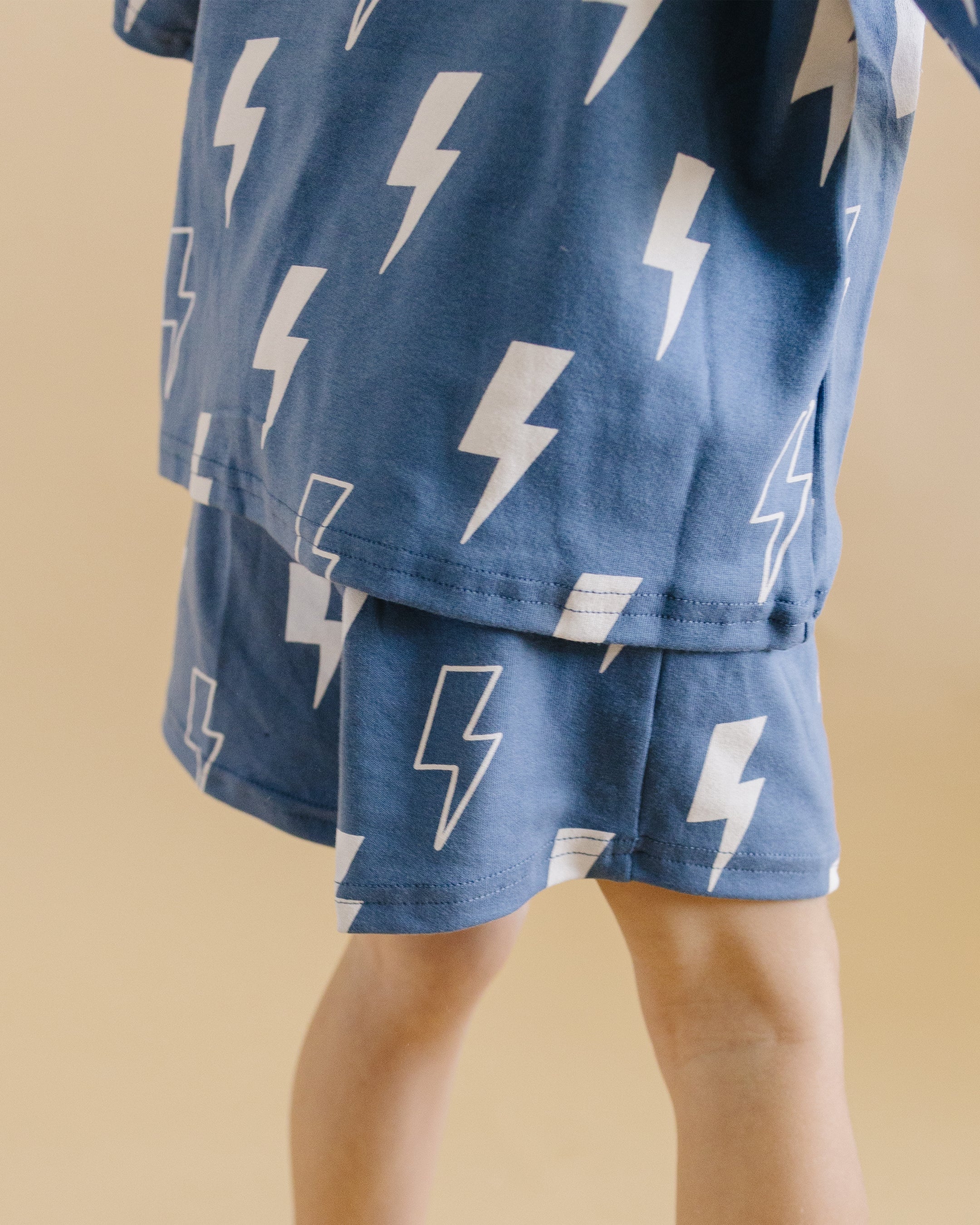 Playful blue bolt shorts set featuring an oversized tee and matching elastic-waist shorts for kids.