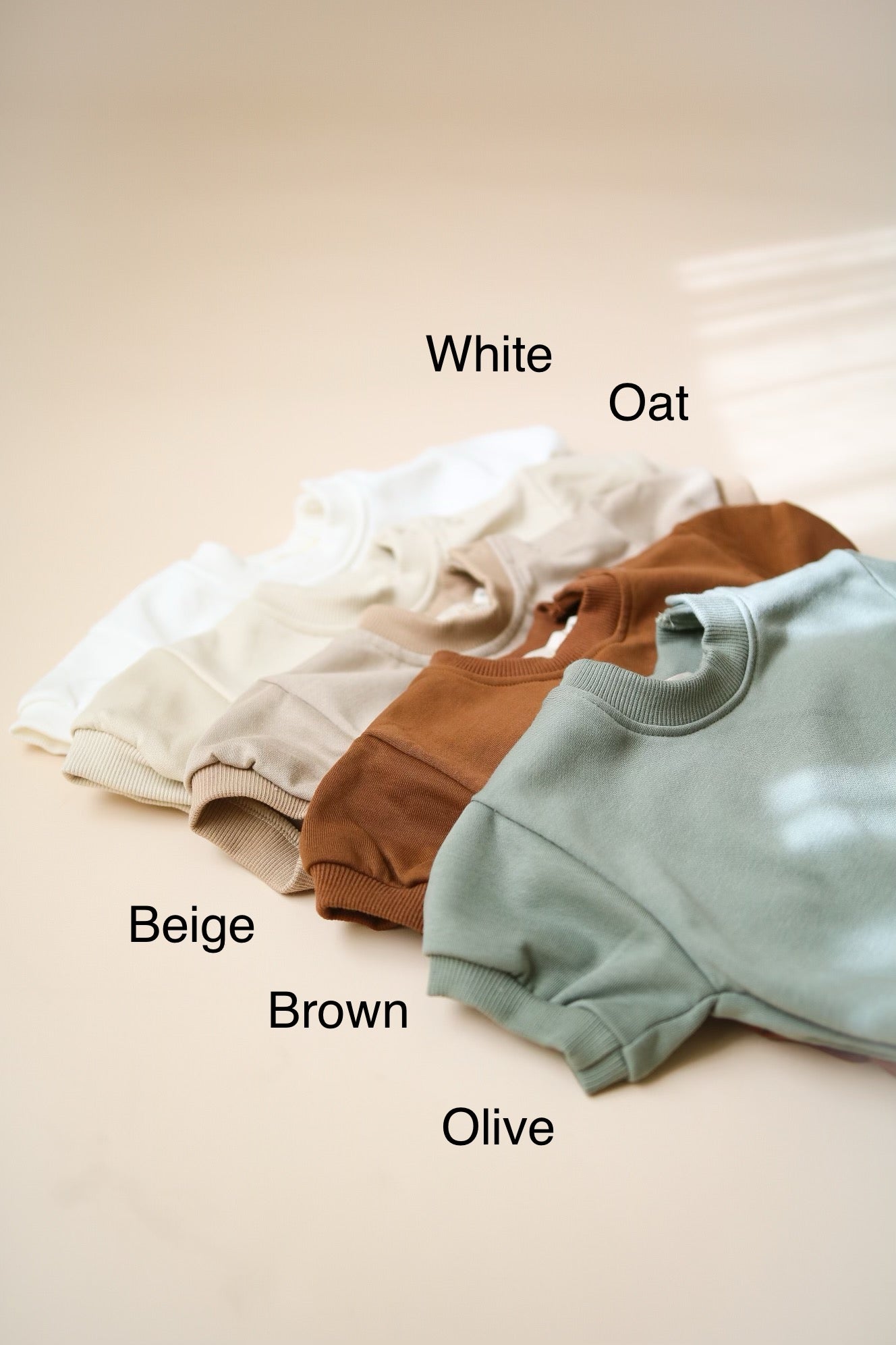 Short sleeve bubble romper in lightweight terry fabric, featuring colors: white, oat, beige, brown, and olive.