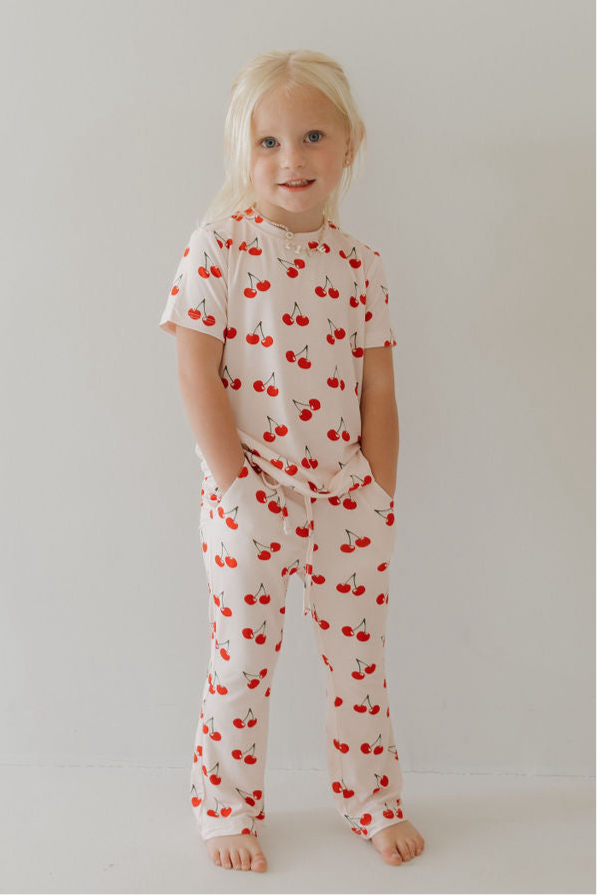 Toddler wearing bamboo short sleeve lounge set with cherry print, perfect for play and sleep.