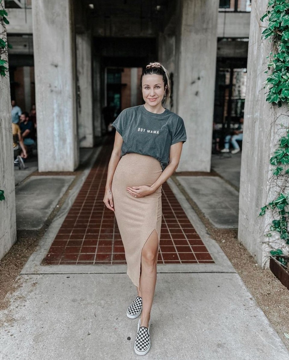 Woman in a ‘Boy Mama’ graphic tee and skirt, embodying casual mom style with trendy vibes.